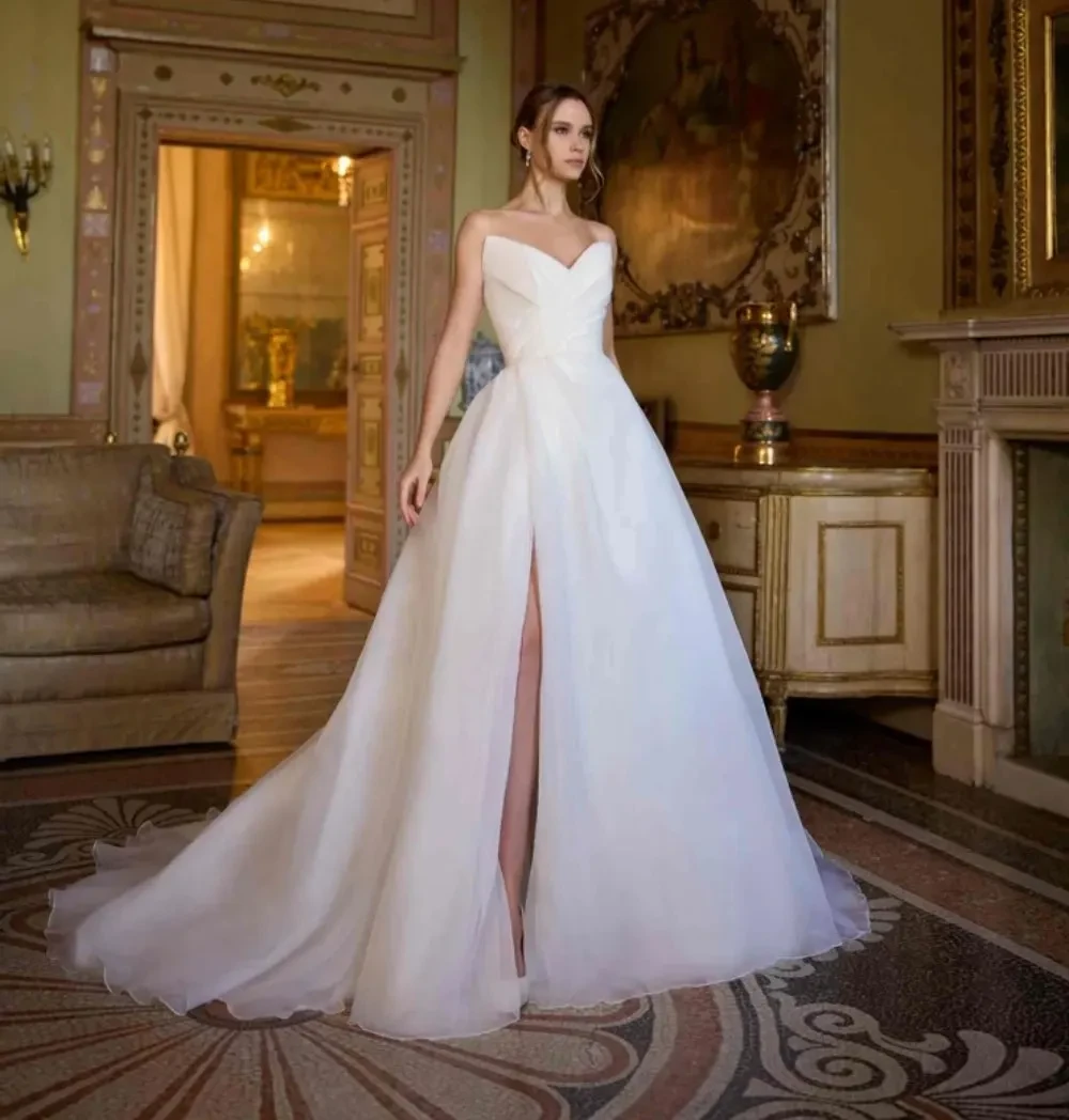Model wearing a white dress by Randy Fenoli