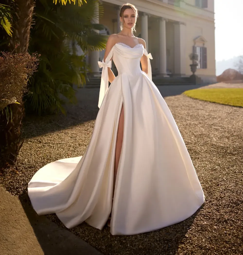 Model wearing a white dress by Randy Fenoli