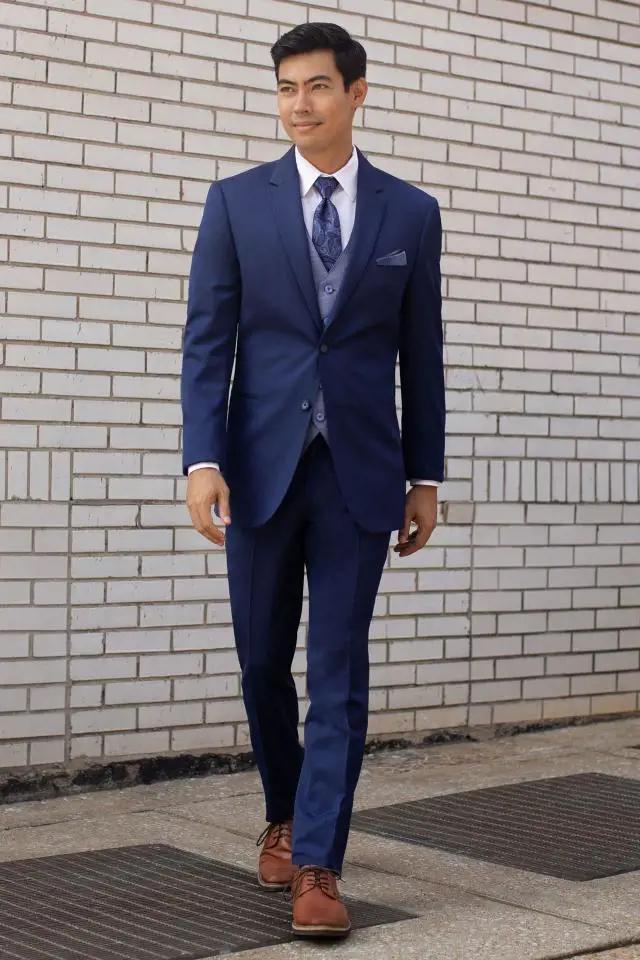 Model wearing a blue suit. Mobile image